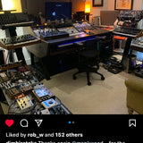 A social media post showing a home studio setup with a large mixing console, multiple synthesizers, a computer monitor, and audio equipment in a room with warm ambient lighting.