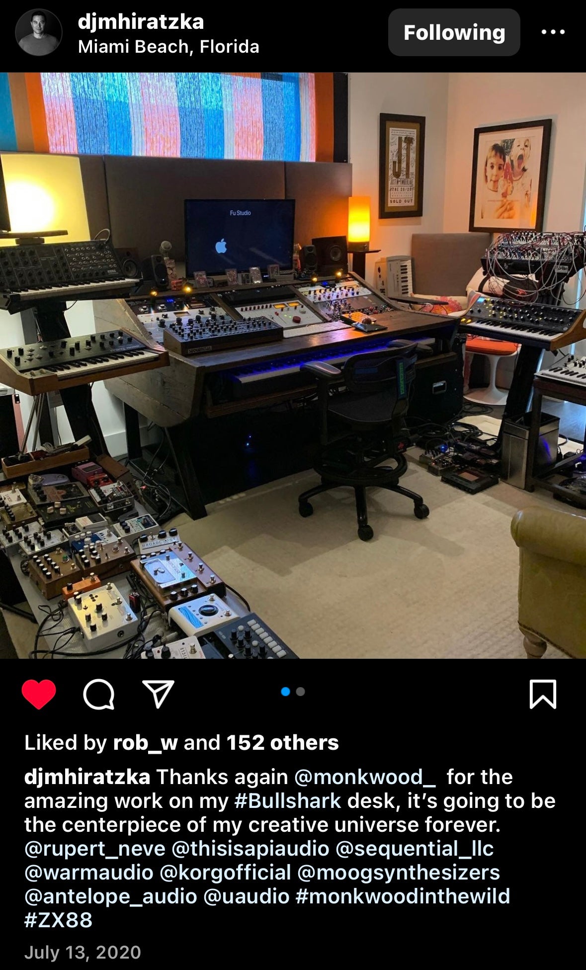 A social media post showing a home studio setup with a large mixing console, multiple synthesizers, a computer monitor, and audio equipment in a room with warm ambient lighting.